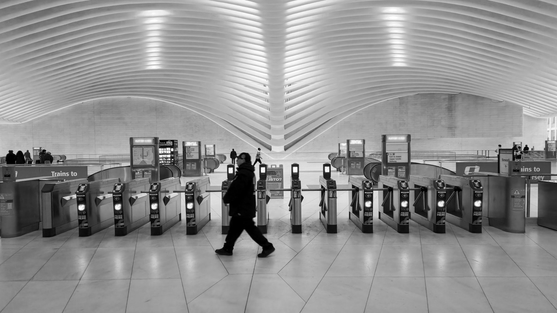 A black and white photo of a train station